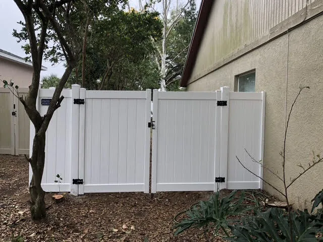 White vinyl fence gate installed at a residential entry