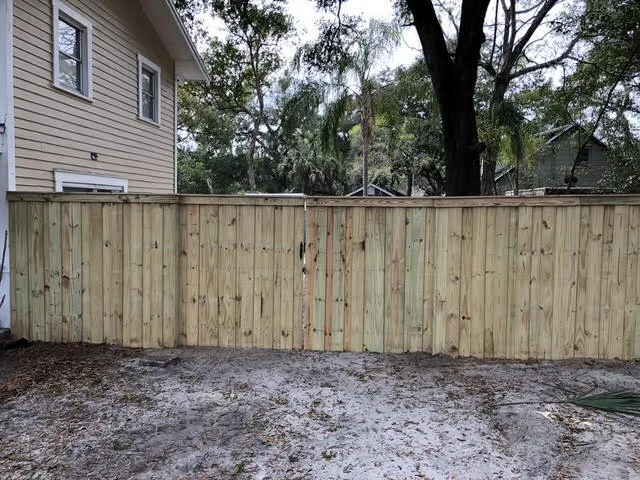 Wood fence with decorative lattice topper