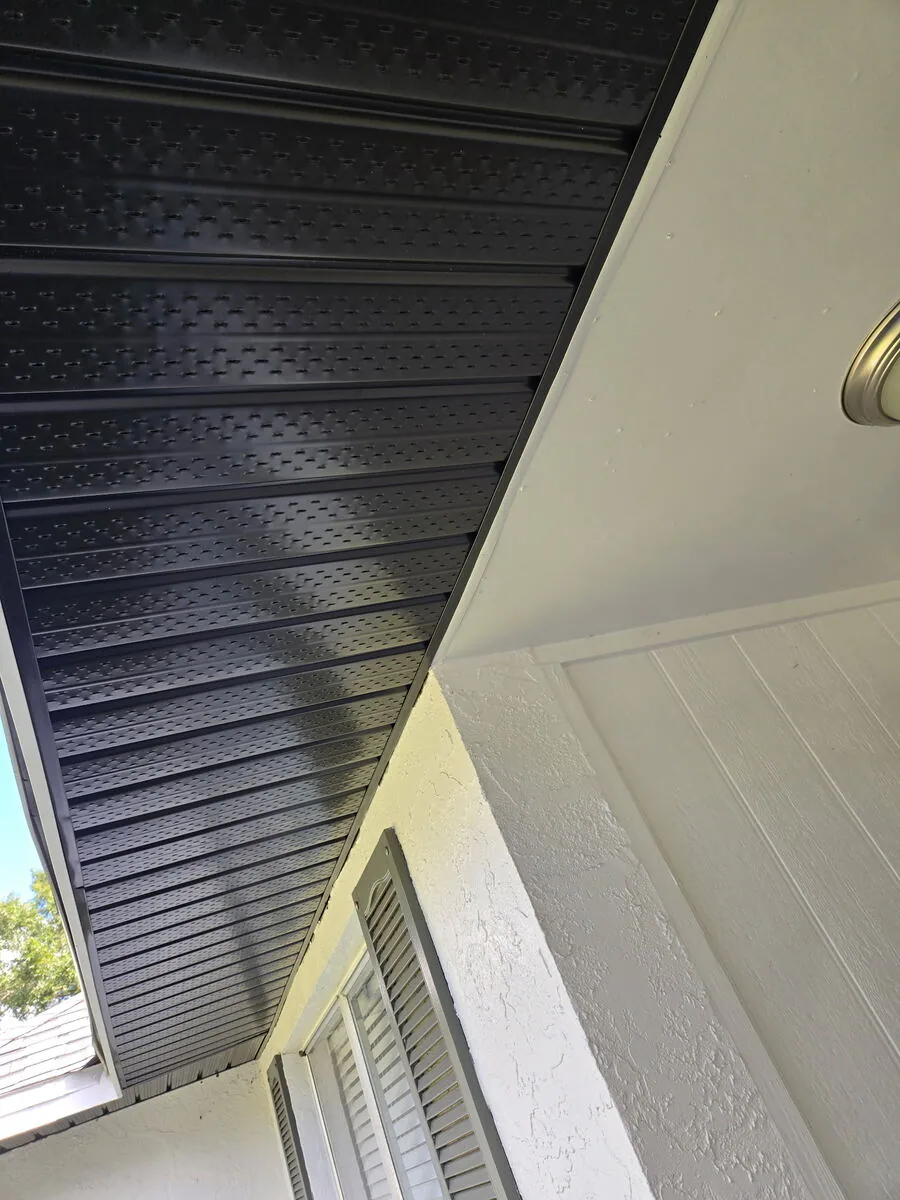 New bronze vented aluminum soffit installed under a roof overhang