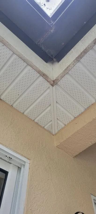 Section of soffit being replaced at a roof corner
